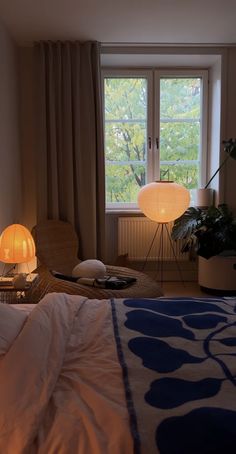 a bed room with a neatly made bed next to a window