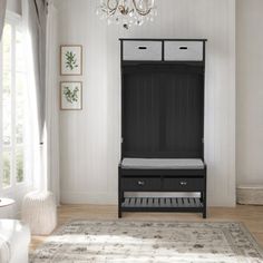 a black and white bedroom with a chandelier hanging from the ceiling