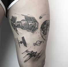 a man's thigh with an image of a space ship and planets on it