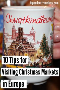 a person holding up a coffee cup with the words 10 tips for visiting christmas markets in europe