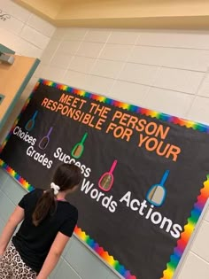 a girl standing in front of a sign that says meet the person responsible for your choice