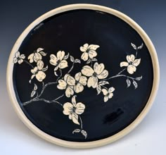 a black and white plate with flowers on it