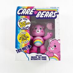 the care bears toy is in its box and has a pink bear on it's chest