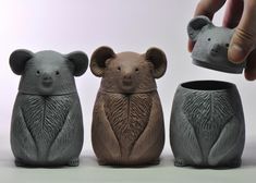 three little bears are sitting next to each other in front of a person's hand