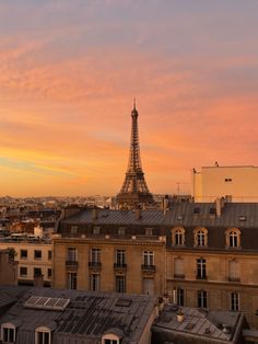 the eiffel tower in paris is seen at sunset as seen from an apartment building