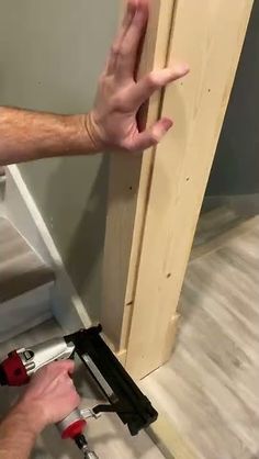 a man is working on a door frame