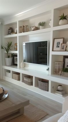 a living room filled with furniture and a flat screen tv on top of a wall