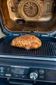 a piece of meat sitting on top of an open grill