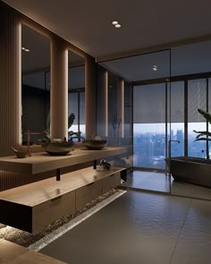 a bathroom with two sinks and large mirrors on the wall next to a bathtub