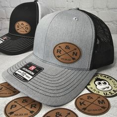 two hats with patches on the front and one has a sticker that says r & n