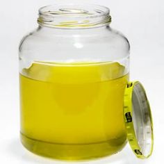 a glass jar filled with yellow liquid