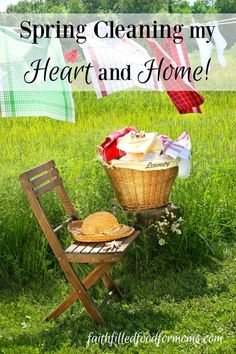 a chair and basket with clothes on it in the grass