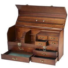 an old fashioned wooden jewelry box with drawers