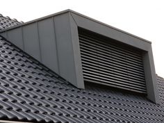 a close up view of the roof of a building with an air vent on it's side