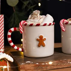 two mugs with hot chocolate and marshmallows in them