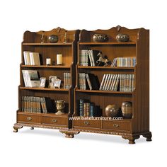 an old fashioned bookcase with many books on the top and two drawers below it