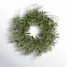 an image of a wreath made out of leaves and berries on a white background with copy space