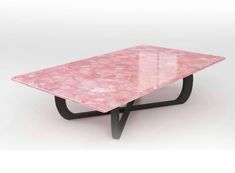 a pink marble coffee table with black metal legs on an isolated white background for display