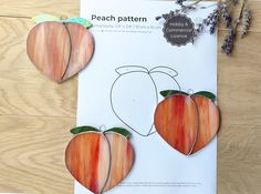 two pieces of paper cut out to look like peaches