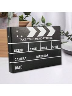 a black and white clapper board with the words take your memory here