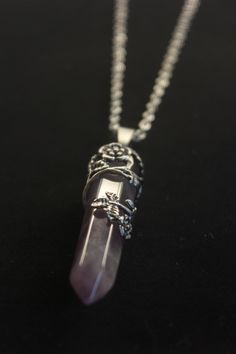 Beautiful natural Amethyst  stone necklace.   Amethyst  is a semiprecious violet stone that is often used in jewelry and for healing purposes. It has been sought after throughout the ages for its stunning colors and ability to stimulate the mind and emotions. The most powerful and popular healing stone.  This crystal is wrapped in a delicate flower and adorned by a durable stainless 20 inch yoga chain. Amethyst Jewelry Aesthetic, Purple Rose Quartz Jewelry For Healing, Amethyst Crystal Necklaces With Round Pendant, Spiritual Lavender Wire Wrapped Necklaces, Mystical Silver Amethyst Crystal Necklace, Purple Amethyst Jeweled Necklaces, Purple Amethyst Pendant Crystal Necklace, Amethyst Crystal Healing Necklace With Round Pendant, Purple Rose Quartz Gemstone Jewelry