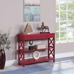 a red console table with books on it