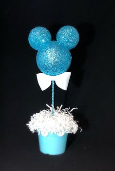 a mickey mouse cake topper in a blue cup