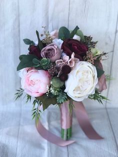 a bridal bouquet with roses and greenery