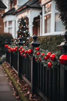 a row of houses with christmas decorations on the fence