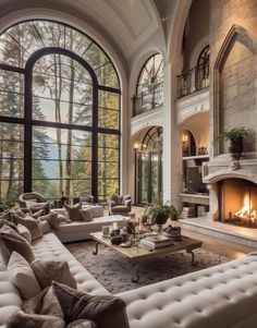 a large living room with two couches and a fire place in the middle of it