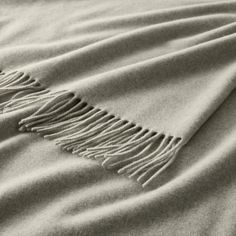 a blanket with fringes on top of it