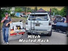 a man standing next to a white truck with the words hitch mounted rack on it