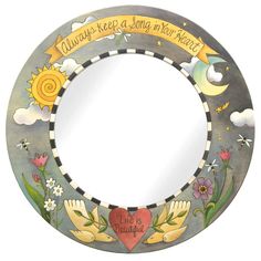 a round mirror with flowers and hands painted on the front, says always keep a song in your heart