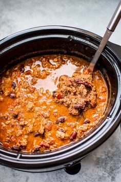 a crock pot filled with chili and meat in the slow cooker, ready to be eaten