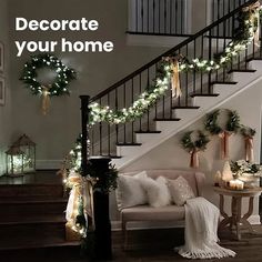 stairs decorated for christmas with lights and wreaths on the bannister railing, next to a couch