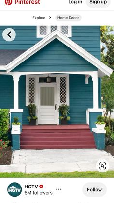 a blue house with red steps and white trim on the front door is seen in this image