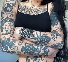 a woman with tattoos on her arms and chest