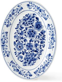 a blue and white plate with floral designs on the rim, isolated against a white background