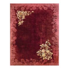 a red area rug with flowers and vines on the border, in front of a white background