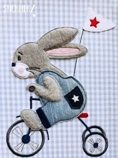 a rabbit riding a bike with a flag on it