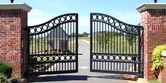 an iron gate is open to the driveway