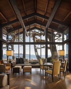 a living room filled with furniture next to a large window covered in windows overlooking the ocean