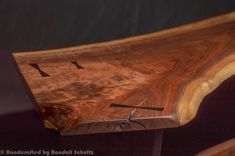 a close up of a wooden bench with birds on it's face and numbers painted on the wood