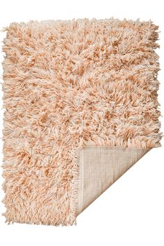 an area rug with a white background and beige fringes on the bottom half of it