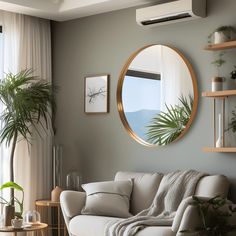 a living room filled with furniture and a round mirror