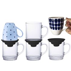 four coffee mugs with lids and handles are shown next to each other, one is holding a teapot