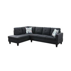 a black sectional couch with pillows on it's back and the seat upholstered