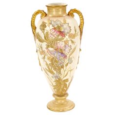 a gold vase with flowers painted on it