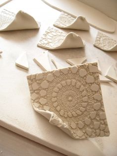 several pieces of art made out of white clay