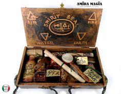 an old wooden box filled with different types of bottles and writing on the inside is labeled spirit sea fire water earth